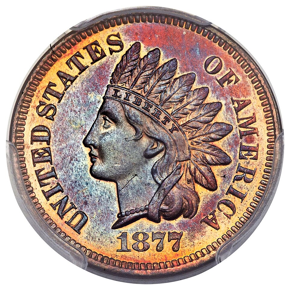 The obverse of the United States Indian Head cent: a female Liberty in profile wearing a Native American feathered headdress.